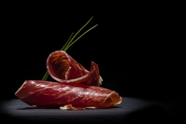 closeup-two-delicious-slices-ham-top-each-other-dark-space